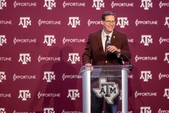 Trev Alberts stands behind a podium at his welcome press conference