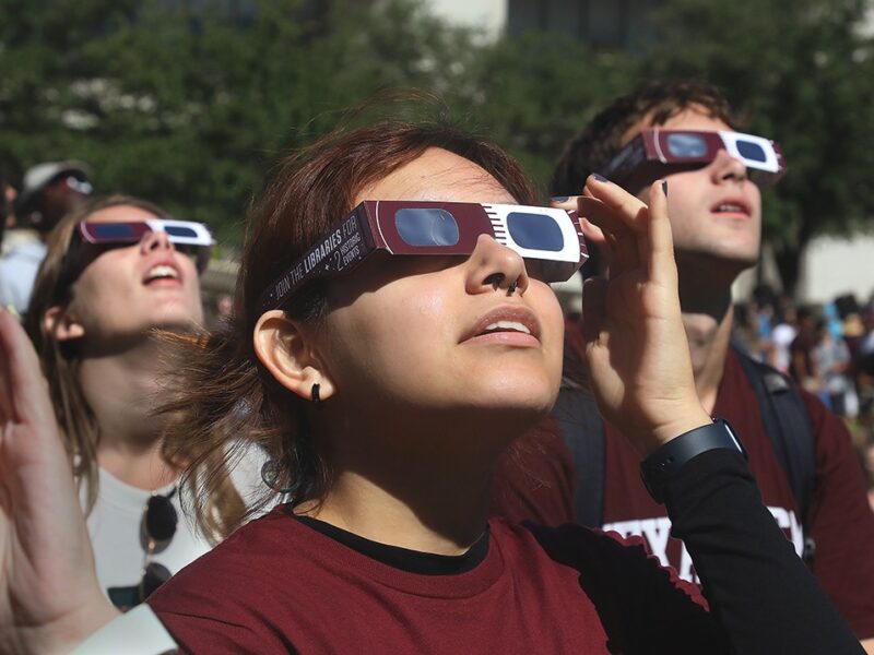 Aggies watching the last solar eclipse with Libraries' viewing glasses