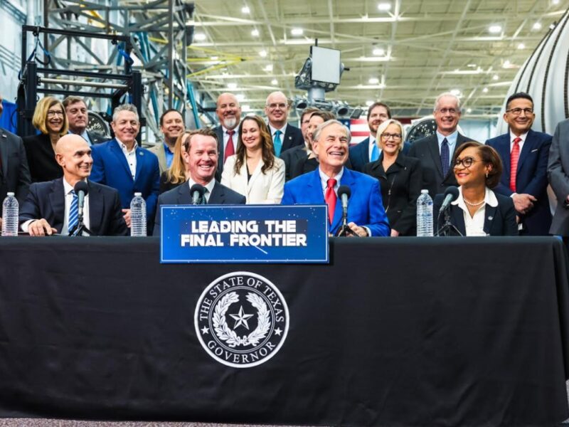 A photo of a group of people surrounding Texas Gov. Greg Abbott during a press event announcing the formation of the Texas Space Commission.