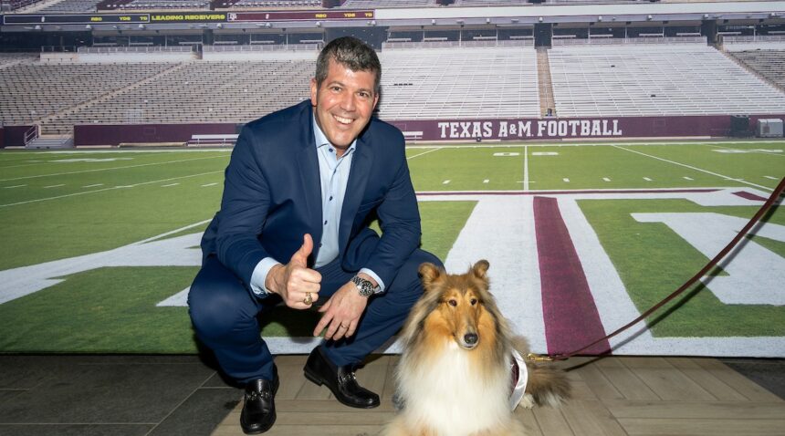 Fernando Palomo poses with Reveille X in front of a Kyle Field backdrop at the afterparty