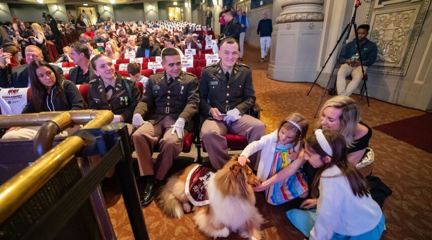 Reveille X receives pets from young fans inside the theatre prior to the screening.