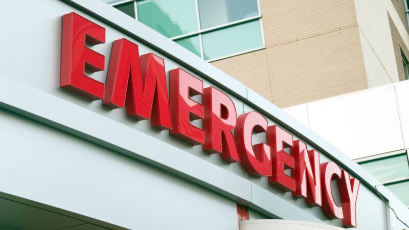A large red emergency sign on a hospital entrance.