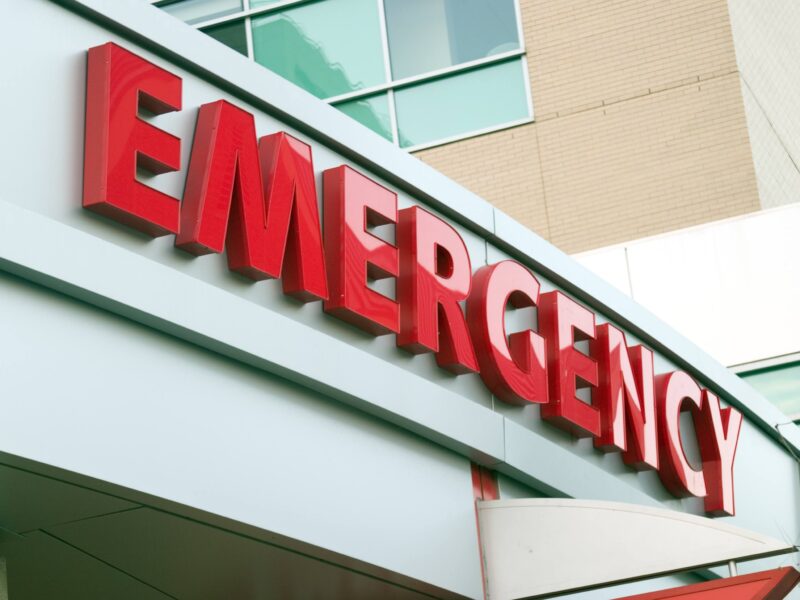 A large red emergency sign on a hospital entrance.