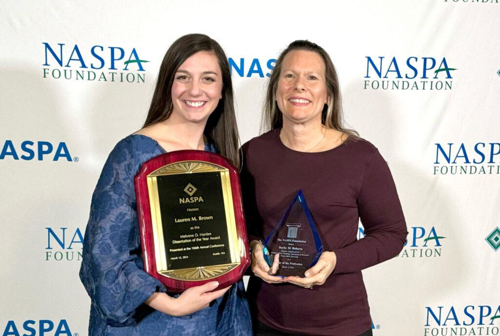 Dr. Darby Roberts and Dr. Lauren Brown posing with their NASPA awards