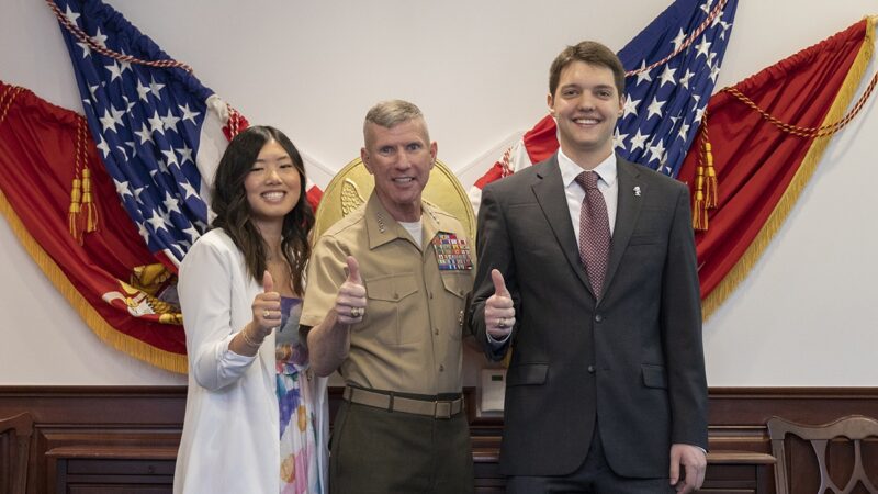 Susan Liu, Gen. Eric Smith and Lee Thornton pose for a photo