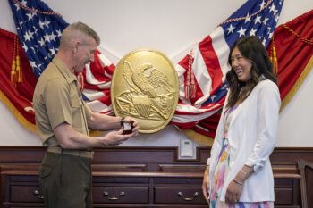 Gen. Eric Smith about to hand Susan Liu her Aggie ring at the Pentagon on April 17, 2024