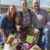 A cadet kneeling along with his parents with Reveille X on the Texas A&M University campus.
