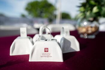 white cowbells with an A&M logo, handed out to spectators to help root on the athletes