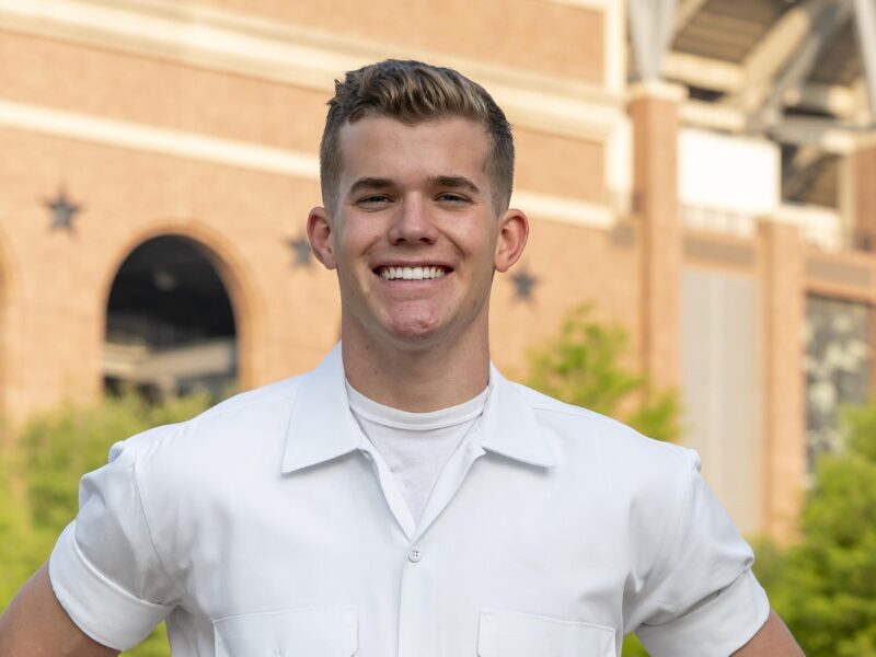 A yell leader poses for a portrait outside of Kyle Field on the Texas A&M University campus.