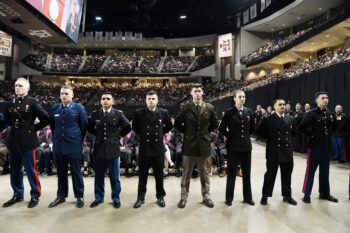 Members of the Texas A&M Corps of Cadets stand during a commissioning ceremony at Reed Arena.