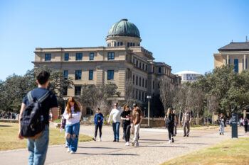 Aggie students walk near the Academic Building on the Texas A&M campus