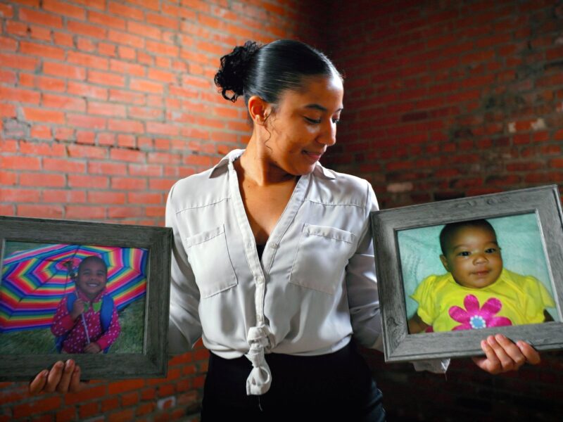 Vargyas, holding framed photographs of her younger sisters and career inspirations Karrina (left) and Sydnee (right), who were among the 24 fatalities in the 2013 Moore tornado.