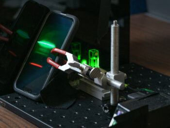 A smartphone records the Raman spectrum of an unknown material (an ethanol solution, in this case) for further analysis.