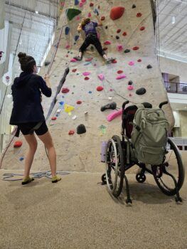 a participant climbing the rock wall