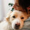 a woman hugging her dog