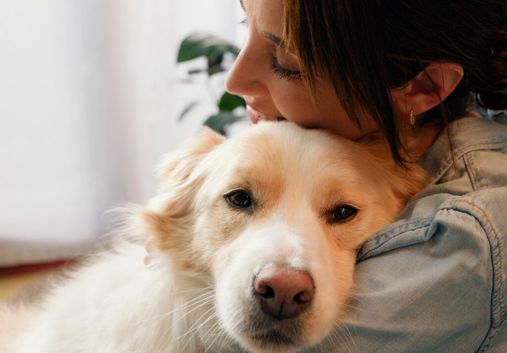 a woman hugging her dog