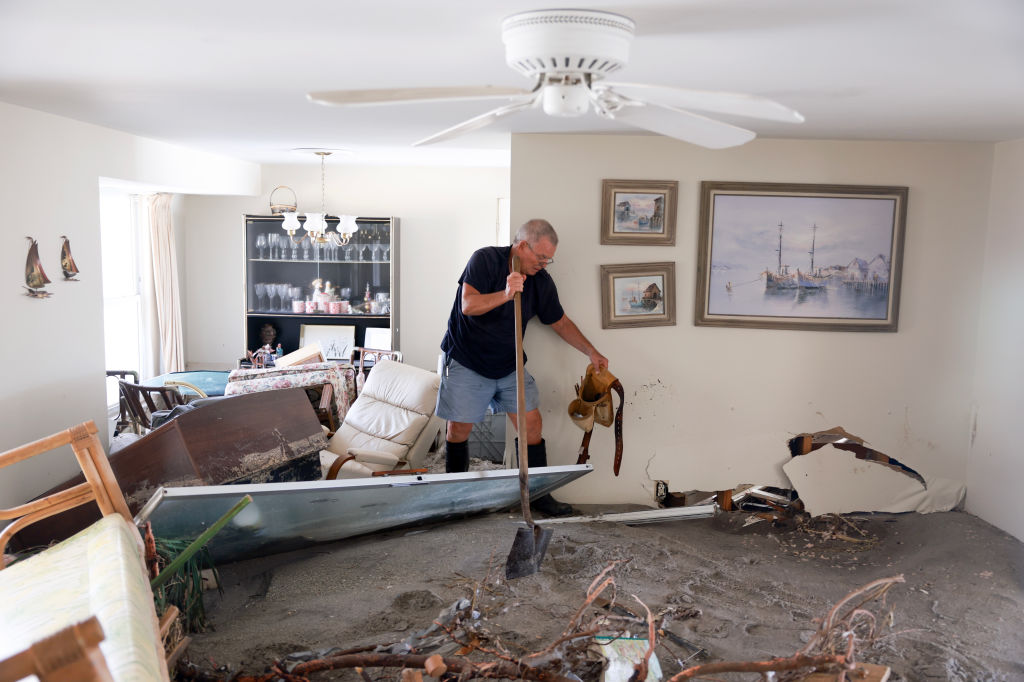 MANASOTA KEY, FLORIDA - OCTOBER 13: Perry Wise salvages what he can from his home full of mud on October 13, 2024 in Manasota Key, Florida. People continue recovering following the storm that made landfall as a Category 3 hurricane in the Siesta Key area of Florida on October 9th, causing damage and flooding throughout Central Florida. (Photo by Joe Raedle/Getty Images)