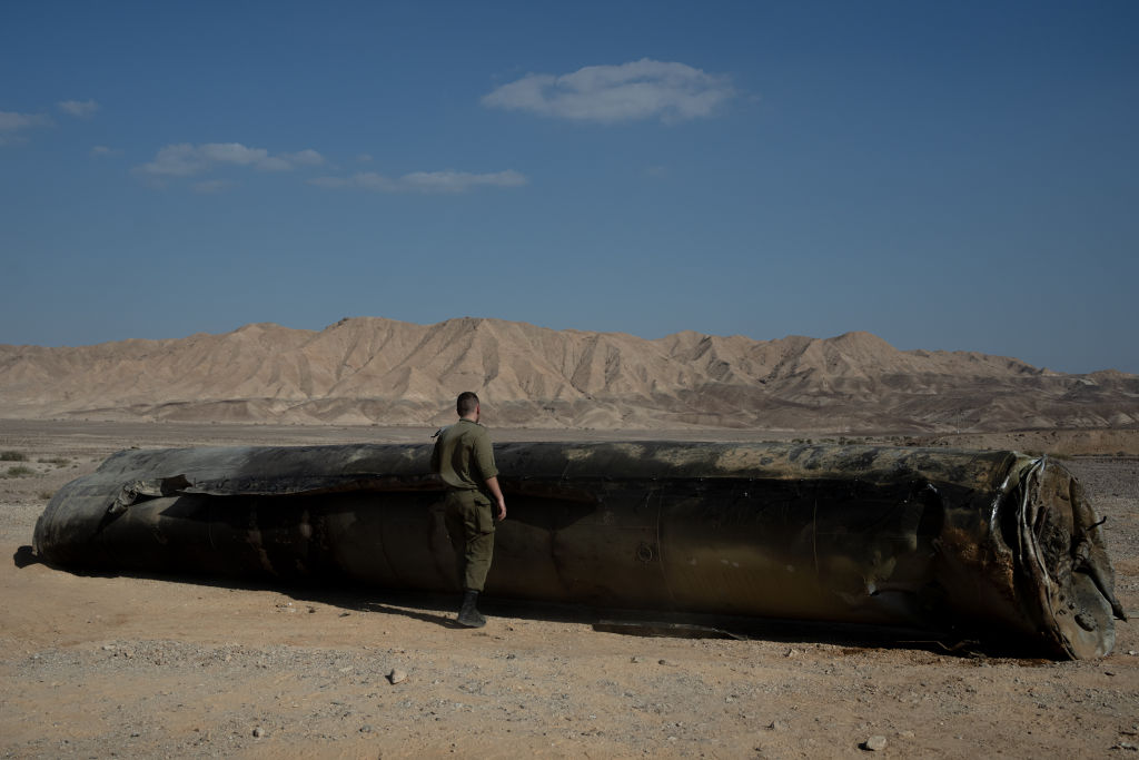 ARAD, ISRAEL - OCTOBER 2: A soldier inspects remains of a missile on October 2, 2024 in Arad, Israel. Last night Iran launched a missile strike on Israel saying the attack was retaliation and citing assassinations they believe Israel carried out in Tehran and Damascus. The attack represents a further escalation in the Middle East conflict. (Photo by Erik Marmor/Getty Images)