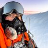 A selfie photo of a mountain climber on top of Mount Everest