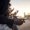 a group of teenagers holding cell phones