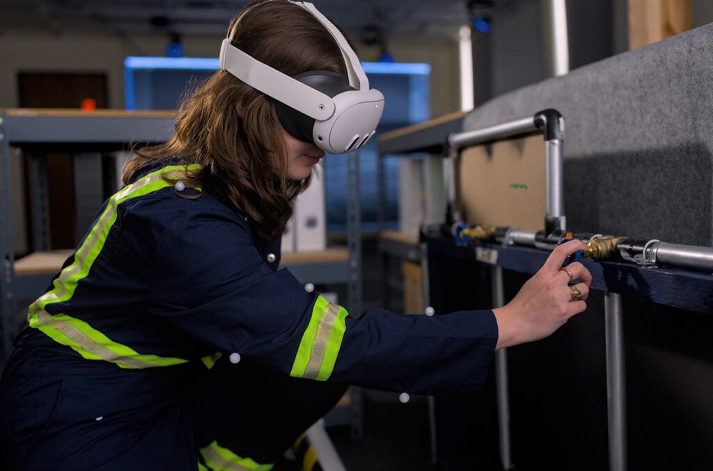 A woman wears a virtual reality headset while performing tasks in a laboratory setting.