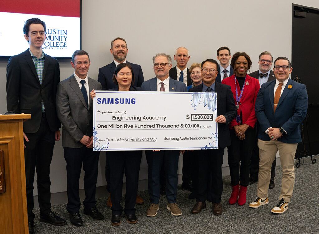 A&M, Austin CC and Samsung reps holding a large check