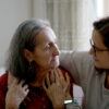 a caregiver puts her arm around a patient at home