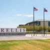 A photo of the sign and flags at the entrance to the Texas A&M-RELLIS campus in Bryan.