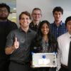 A photo of a group of students standing with a safety device they designed for a Small Modular Reactor.