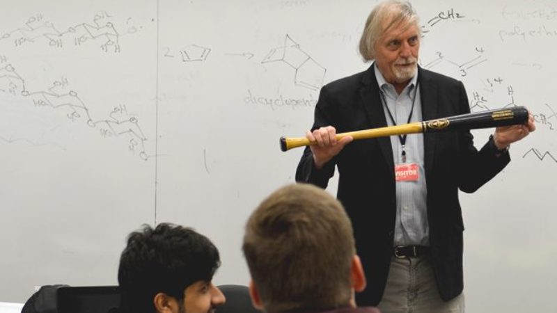 Berbreiter with a bat in front of class room