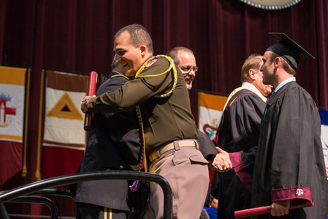 Student receiving diploma on stage