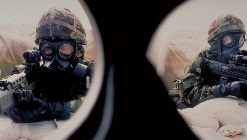 Two soldiers with guns through the lens of binoculars