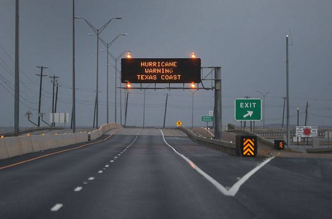 A road sign warns travelers of the the approaching Hurricane Harvey on August 25, 2017 in Corpus Christi, Texas. Hurricane Harvey has intensified into a hurricane and is aiming for the Texas coast with the potential for up to 3 feet of rain and 125 mph winds. (Joe Raedle/Getty Images)