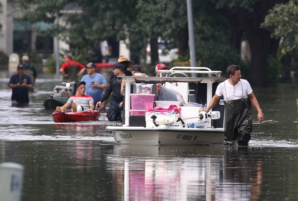 People use boats to help bring items out of homes in an area where a mandatory evacuation is still under effect after flood water inundated them after torrential rains caused widespread flooding during Hurricane and Tropical Storm Harvey on September 3, 2017 in Houston, Texas. (Photo by Joe Raedle/Getty Images)