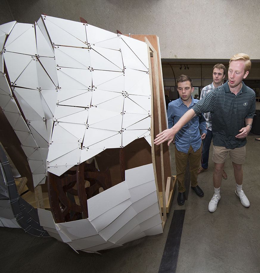 Hayden Hood, a sophomore environmental design major from Austin, explains the design, construction and symbolism behind the sculpture that he and his classmates created to represent Hurricane Harvey rainfall in three areas of Houston.