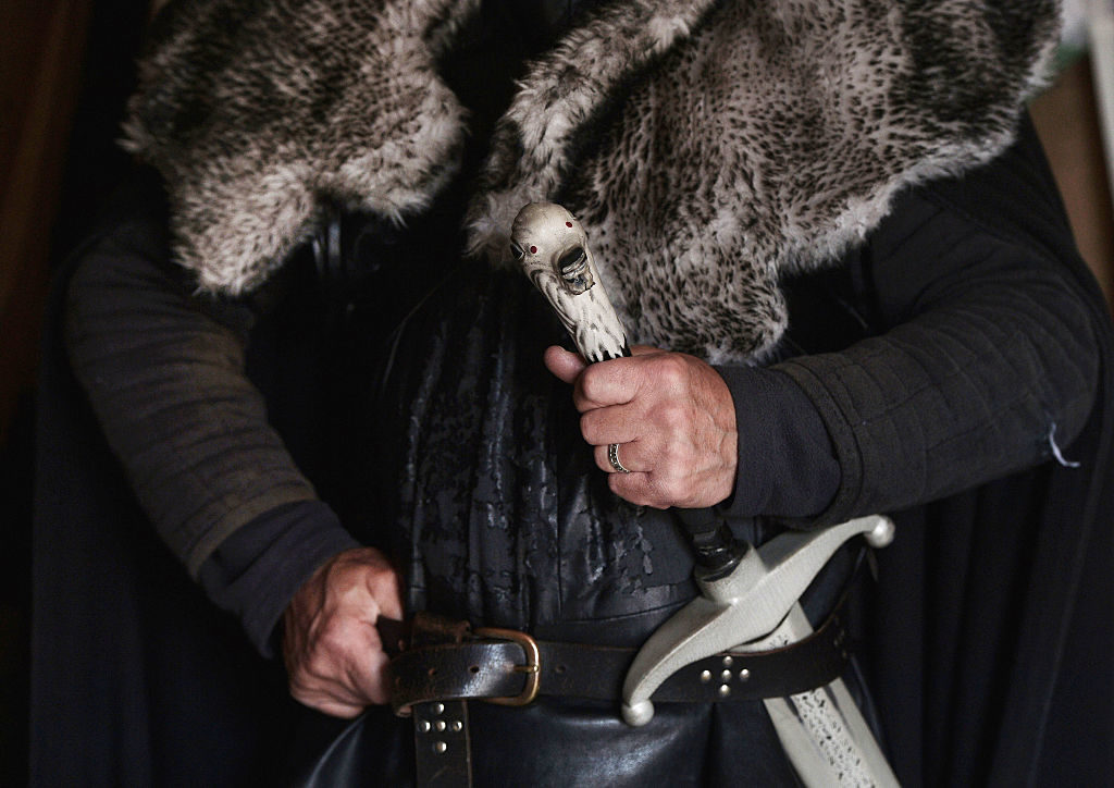 BELFAST, NORTHERN IRELAND - AUGUST 13: A close up of a Game of Thrones tour guide's costume and sword in Strangford on August 13, 2015 in Belfast, Northern Ireland. According to recent audited figures from Northern Ireland Screen, the HBO produced fantasy adventure television series Game of Thrones has contributed an estimated £110m to the Northern Ireland economy. Many local companies have profited from providing services during production creating more than 900 full-time and 5,700 part-time jobs in the process. Due to the popularity of the series various locations highlighted on screen have become tourist attractions around the province. (Photo by Charles McQuillan/Getty Images)