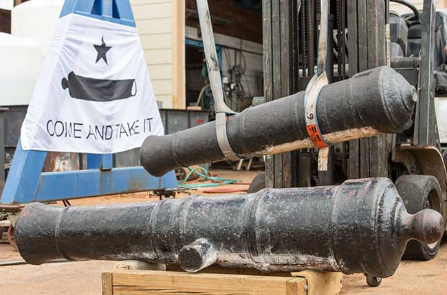 Two cannons from the Alamo being lifted for conservation at the Conservation Research Laboratory at Texas A&M