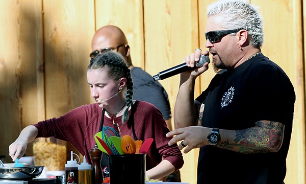 Celebrity chef Guy Fieri coaches Dallas County 4-H member and cooking contest winner Harper Burt at the State Fair