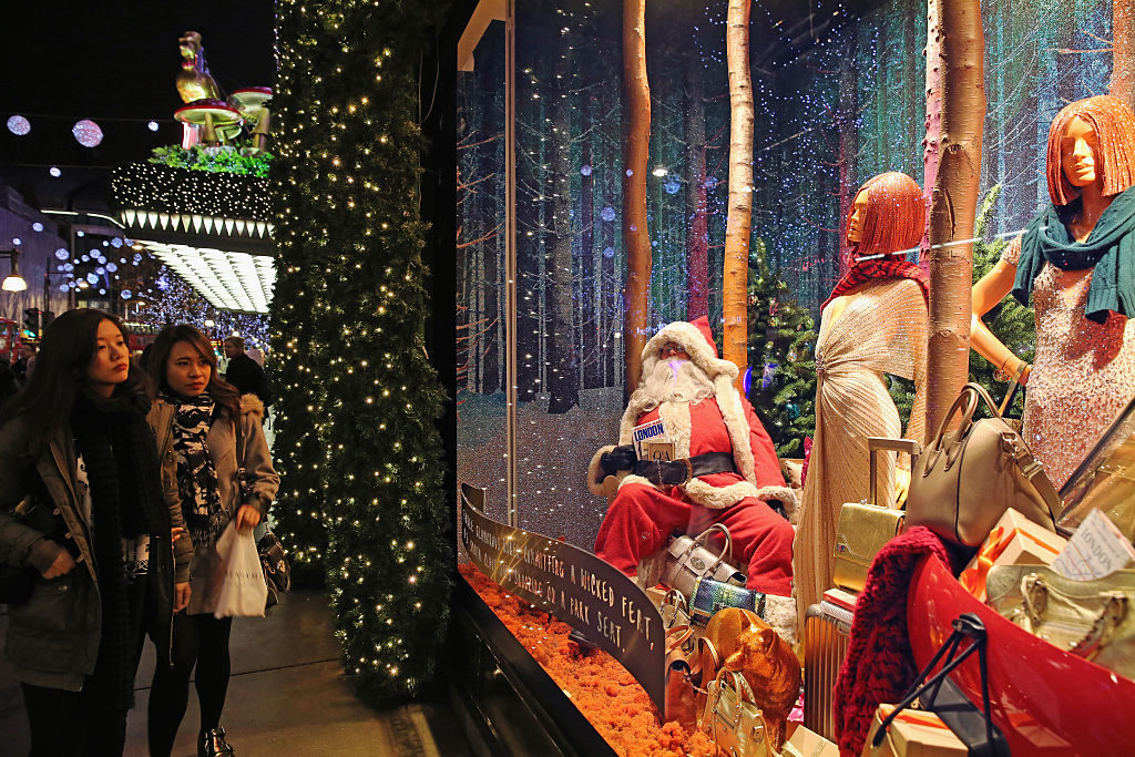 Christmas shoppers look in to decorated store windows. (Dan Kitwood/Getty Images)