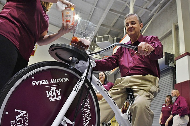 Texas A&M University System Chancellor John Sharp helped kick off the Healthy Texas initiative in Lufkin astride a “smoothie bike,” which blends health-conscious ingredients via pedal power. (Texas A&M AgriLife Extension Service /Adam Russell)