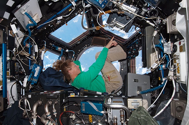 IN SPACE - JULY 16: In this handout image provided by the National Aeronautics and Space Administration (NASA), NASA astronaut Sandy Magnus mission specialist for space shuttle Atlantis STS-135, takes in the view while sitting in the Cupola addition of the International Space Station July 16, 2011 in space. Space shuttle Atlantis is on the last leg of a 12-day mission to the International Space Station where it delivered the Raffaello multi-purpose logistics module packed with supplies and spare parts. This was the final mission of the space shuttle program, which began on April 12, 1981 with the launch of Colombia. (Photo by NASA via Getty Images)