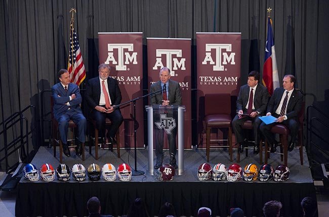 Texas A&M University President Michael K. Young welcomes Texas A&M football coach Jimbo Fisher to Aggieland during a press conference Monday.