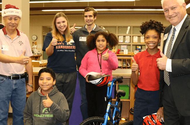 Treasure Forest Elementary students received bikes from C.A.M.P. Aggie mentors.