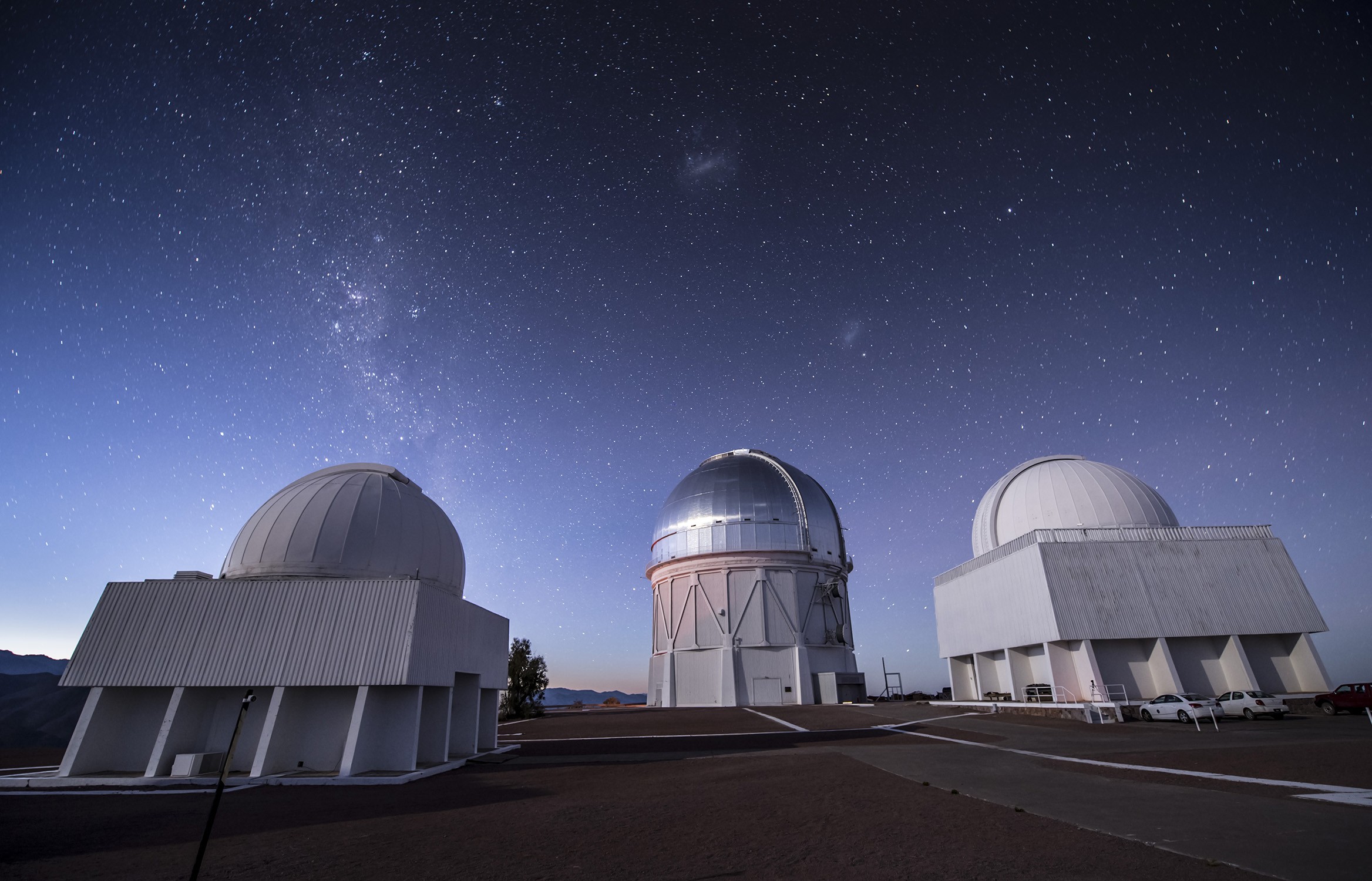 Starry skies over Cerro Tololo Inter-American Observatory in Chile and the 4-meter Victor M. Blano Telescope (center), home to the 570-megapixel Dark Energy Camera and unprecedented discovery potential for astronomers at Texas A&M University and around the world as members of the Dark Energy Survey. (Credit: Fermilab.)