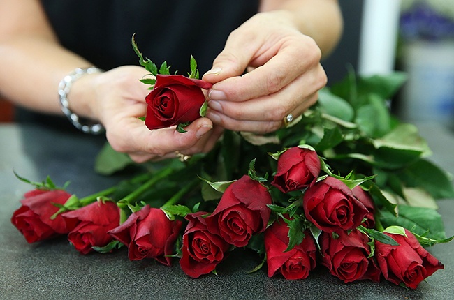 SYDNEY, AUSTRALIA - FEBRUARY 12: A florist prepares a bunch of roses as Sydneysiders prepare for Valentine's Day on February 12, 2014 in Sydney, Australia. St. Valentine's Day or the Feast of Saint Valentine began as a celebration of the early Christian Saint Valentinus. From the 18th Century onwards it has steadily transformed into a celebration of romantic love and sentiment in many countries around the world. (Photo by Brendon Thorne/Getty Images)