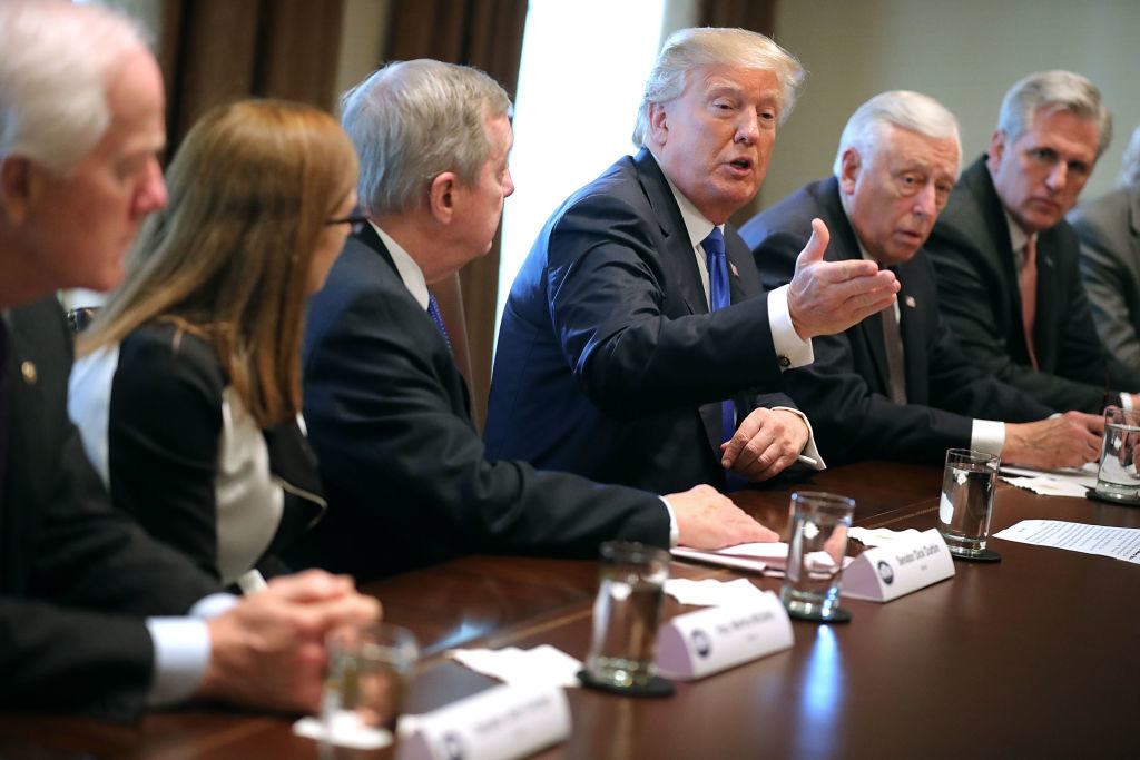 U.S. President Donald Trump (C) presides over a meeting about immigration with Republican and Democrat members of Congress, including (L-R) Senate Majority Whip John Cornyn (R-TX), Rep. Martha McSally (R-AZ), Senate Minority Whip Richard Durbin (D-IL), House Minority Whip Steny Hoyer (D-MD) and House Majority Leader Kevin McCarthy (R-CA) in the Cabinet Room at the White House January 9, 2018 in Washington, DC. In addition to seeking bipartisan solutions to immigration reform, Trump advocated for the reintroduction of earmarks as a way to break the legislative stalemate in Congress. (Photo by Chip Somodevilla/Getty Images)