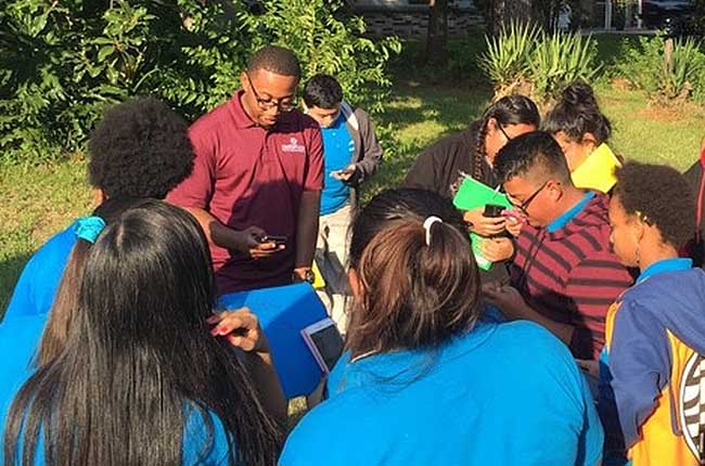 Philip Berke's graduate students lead a group of Houston high school students in using an iPhone app they created to assess stormwater drainage systems