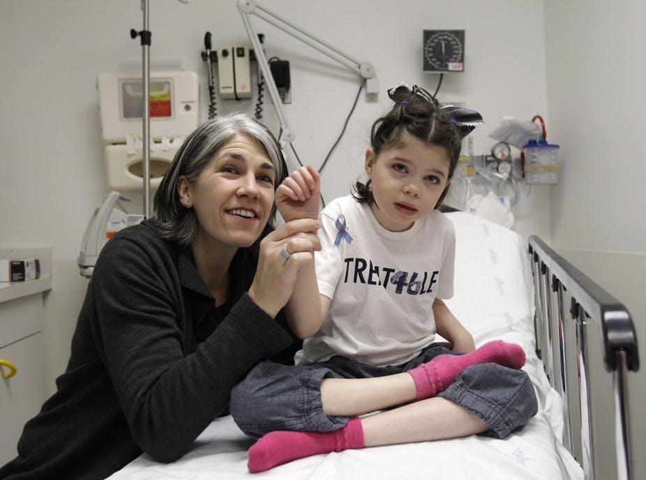 In this March 18, 2011 photo, Cassidy Hempel waved at hospital staff as she was being treated for a rare disorder. Her mother Chris, left, fought to gain permission for an experimental drug. AP Photo/Marcio Jose Sanchez