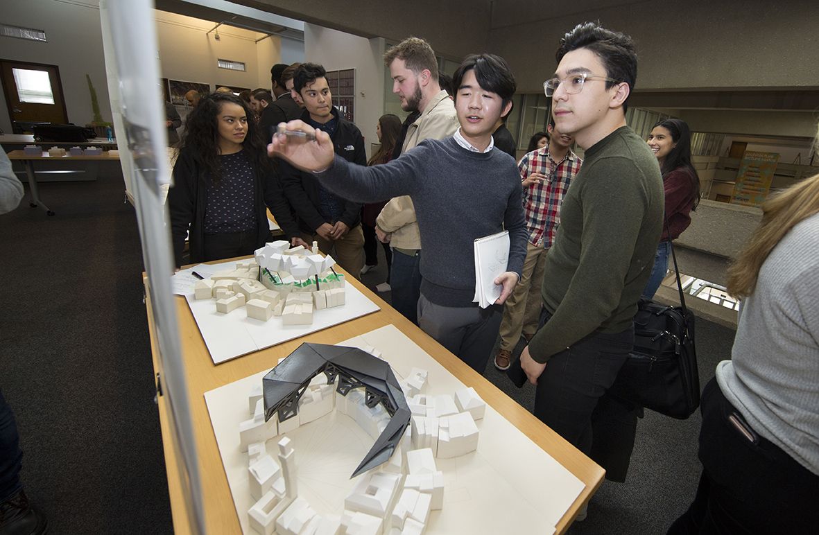 Students explain their design concept to review visitors. 