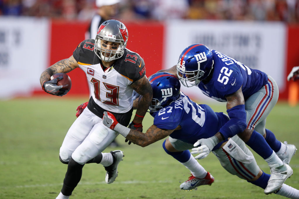 TAMPA, FL - OCTOBER 01: Mike Evans #13 of the Tampa Bay Buccaneers runs for a first down after a catch against Darian Thompson #27 and Jonathan Casillas #52 of the New York Giants in the fourth quarter of a game at Raymond James Stadium on October 1, 2017 in Tampa, Florida. The Bucs defeated the Giants 25-23. (Photo by Joe Robbins/Getty Images)